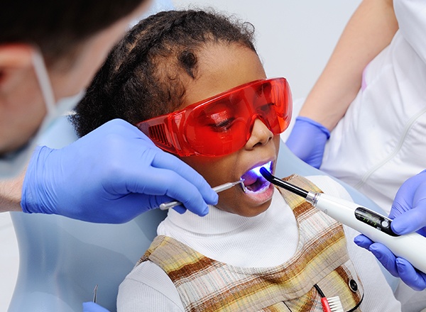 Child receiving dental sealant treatment